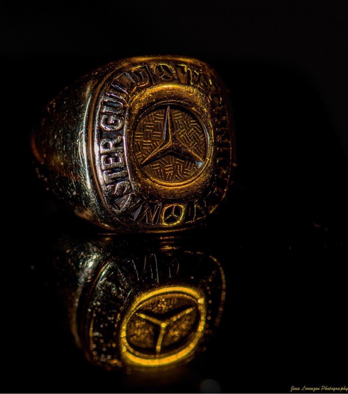 Jens Lorenzen’s Mercedes-Benz Master Guild award ring photographed on a reflective black surface